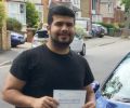 Emilio with Driving test pass certificate
